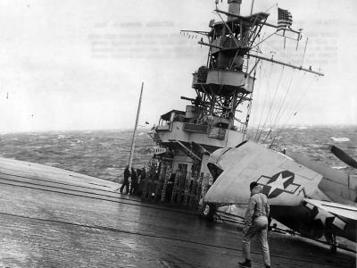 TBF Avenger on deck of carrier moving thru heavy seas