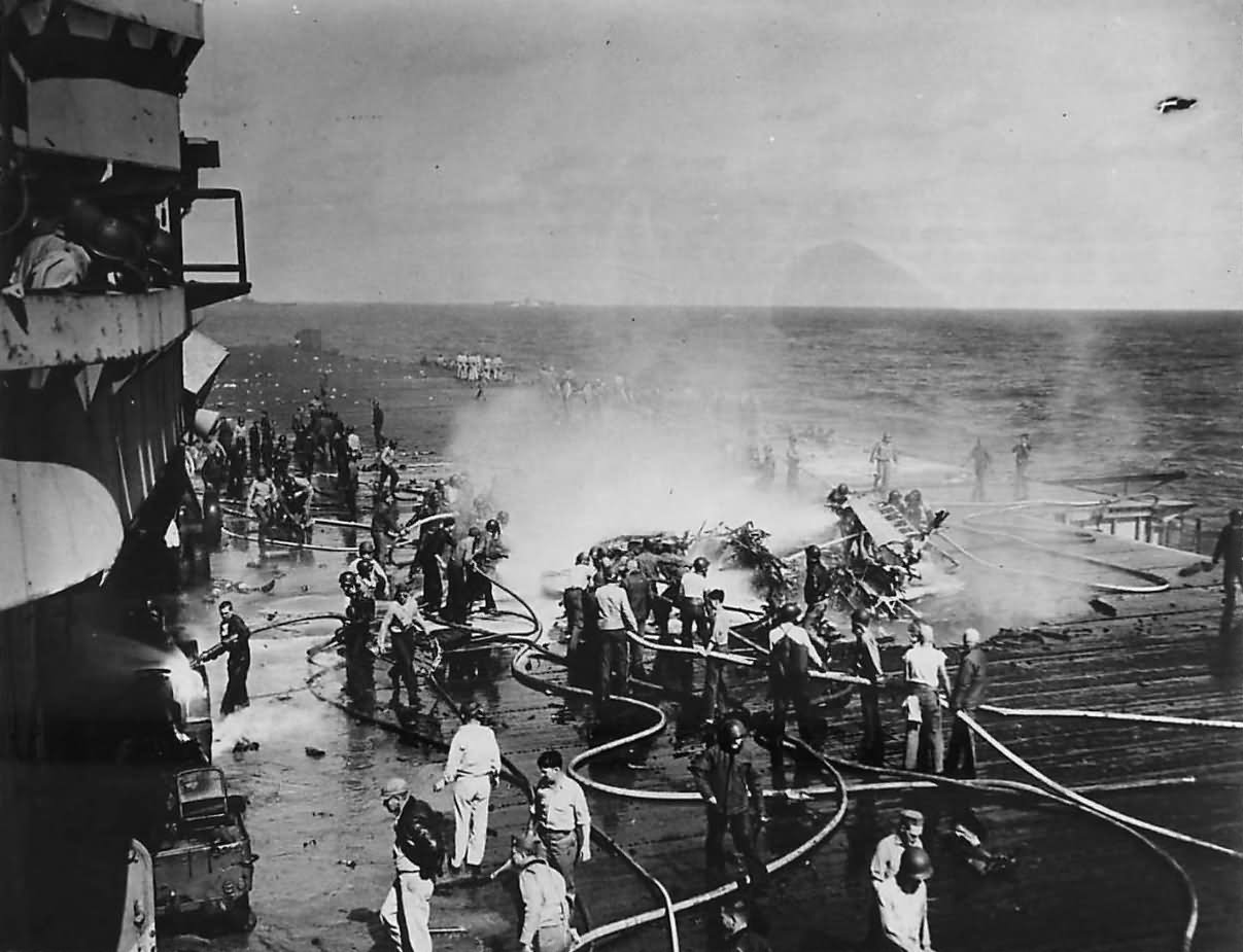 Crew Fight Fire of Burning TBM Avenger piloted by Lt. C.R. Dean of VT-124 on Deck of USS HANCOCK 21 January 1945 2