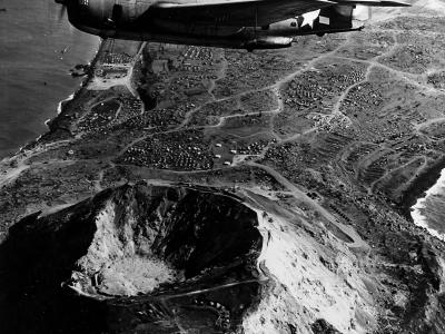 TBM-3 Avenger flies over Mount Suribachi March 1945