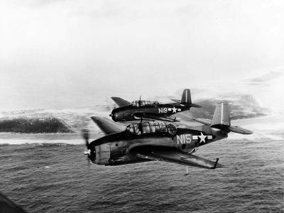 TBM Avengers N15 and N19 of Composite Squadron VC-63 off the escort carrier USS Natoma Bay (CVE-62) pictured in flight over Wotje Atoll on February 9, 1944