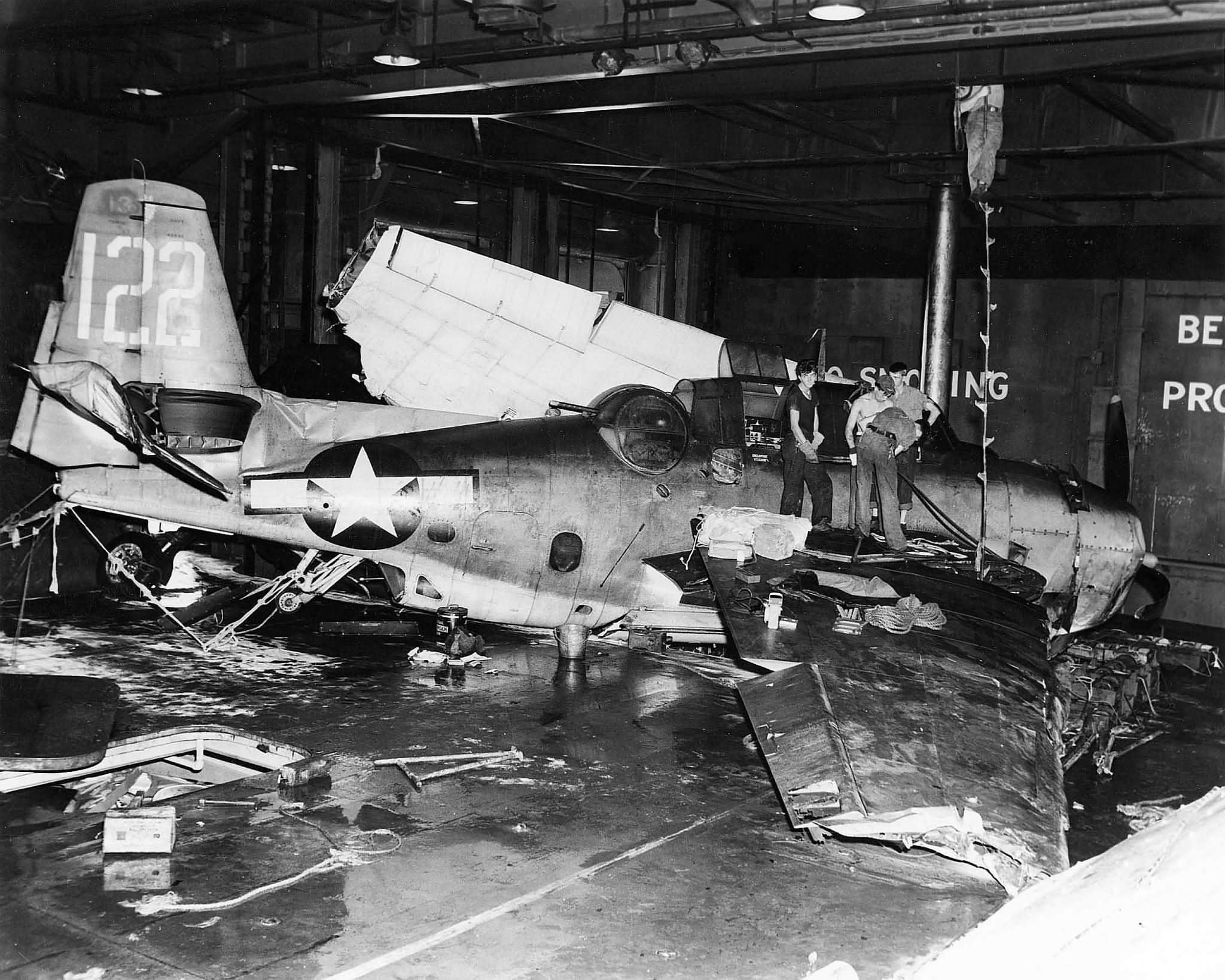 Destroyed TBM Avenger #122 on the hangar deck of the USS Monterey ...