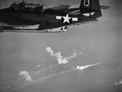 TBM of VB-7 flying from the USS Hancock over burning ships of a Japanese convoy