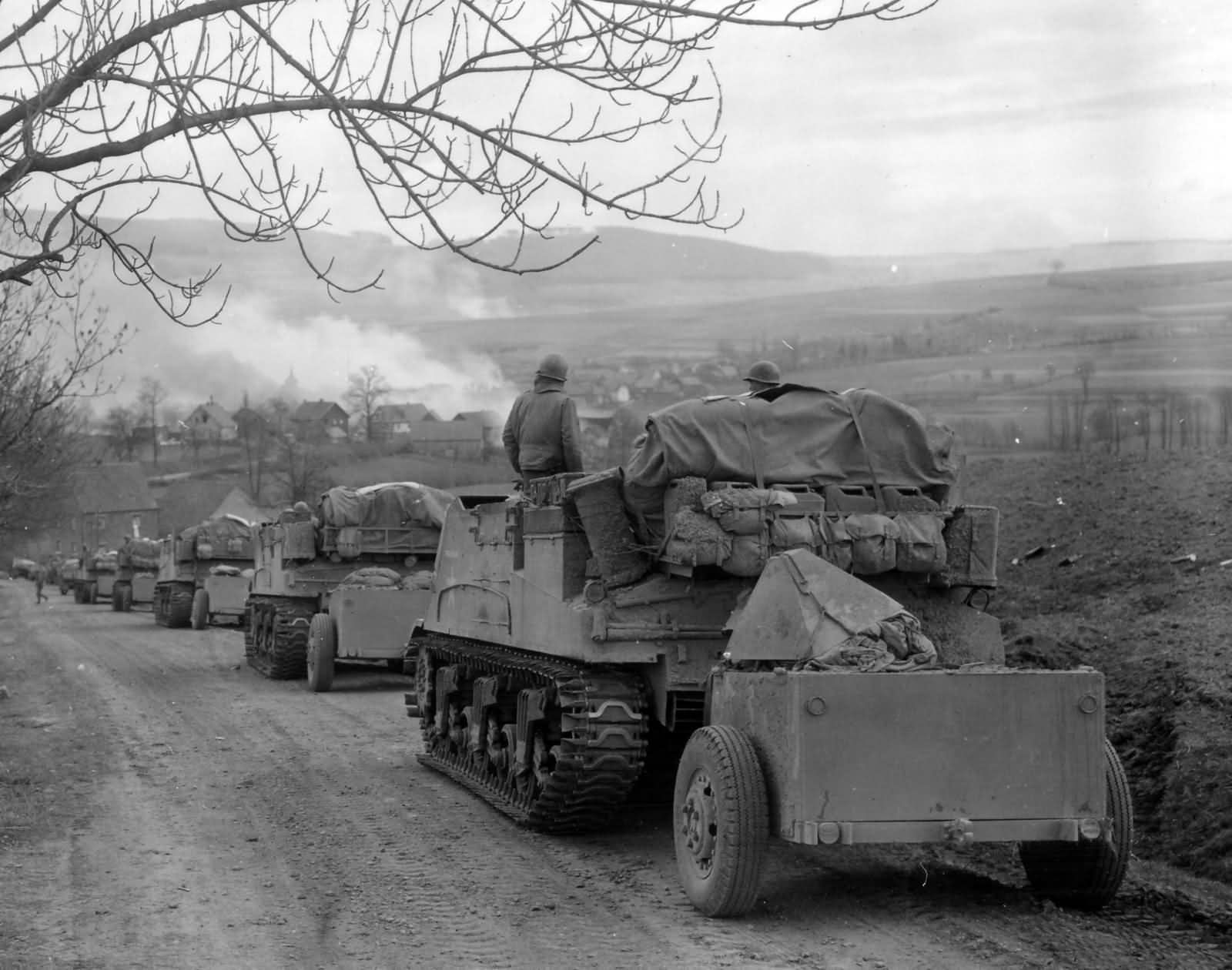 11h Armored Division M7B1 Priest Battery Rolls into Burning Obernust Germany April 1945