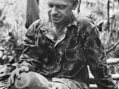 Chaplain shows Japanese bullet hole in helmet