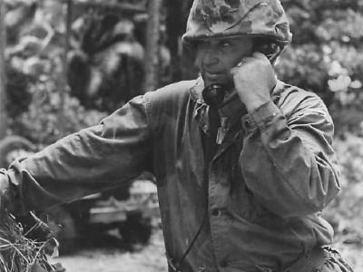 Marine directs artillery from field telephone