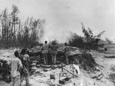 Protected by pillboxes Americal Division troops watch dive bombers