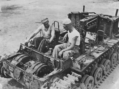 Troops of the 23rd Americal Division riding an abandoned Japanese tractor on Bougainville