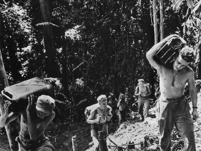 Troops of the 37th Infantry Division carrying 5-gallon cans of water