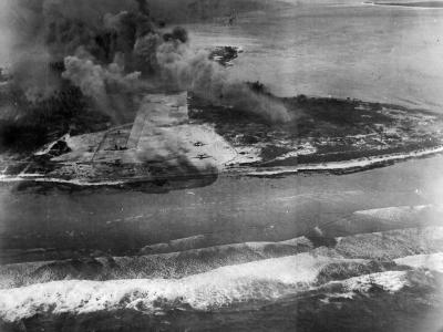 Smoke rises from Eniwetok after attacks by US Navy carrier aircraft 3 February 3 1944