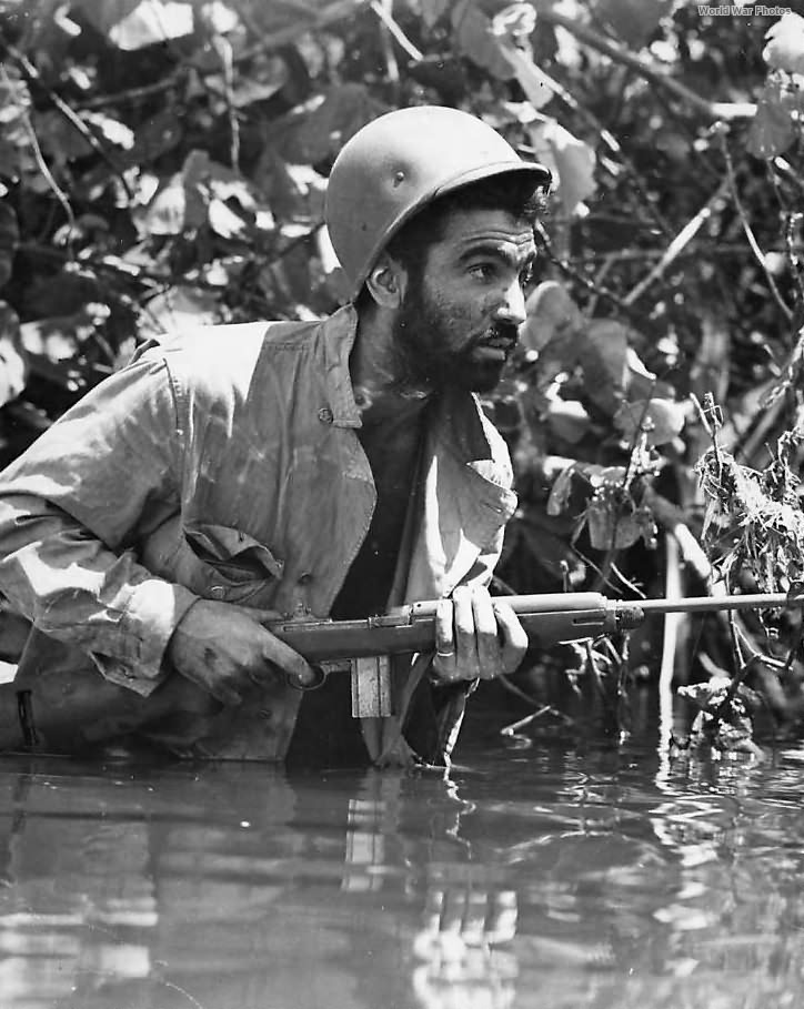 Marine moves thru swamp near Hill 660 on Cape Gloucester