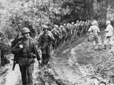 Marines march thru jungle