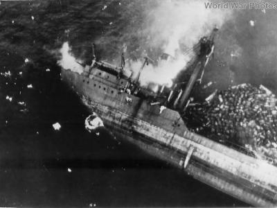 Japanese crew going over side as Kitsugawa Maru sinks at Apra Harbor 1944