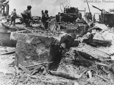 Marines and M4 amid ruins of Old Marine Barracks on Guam