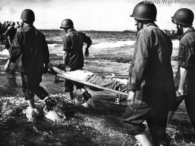 Shipmates carry coast guardsman wounded during Invasion of Guam