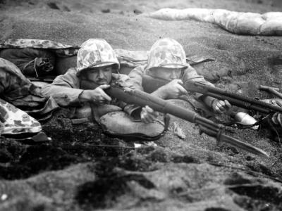 A pair of Marines in a dug out position await a Japanese counter attack