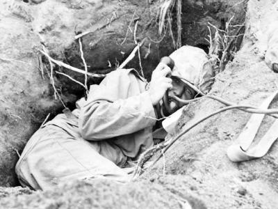 Iwo Jima Marine in foxhole on radio
