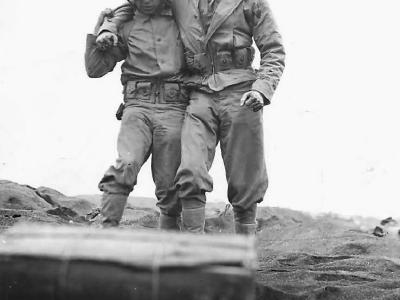 Marine of 5th Division helps wounded comrade on Iwo Jima