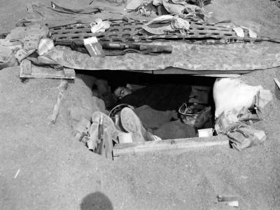 Marine sleeping in foxhole on Iwo Jima