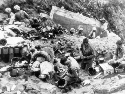 Marines in large hole some praying