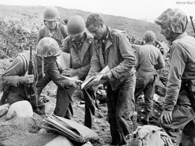 Marine patrol studies Japanese maps on Iwo Jima