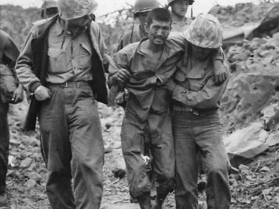 Marines help wounded Japanese Prisoner on Iwo Jima