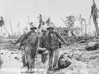 Corpsmen carry a wounded Marine on a stretcher
