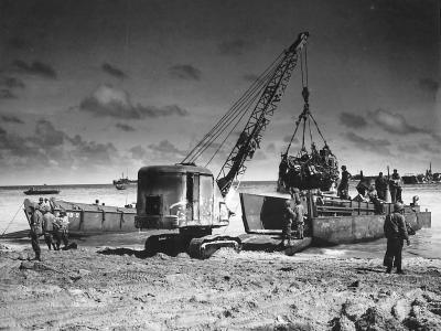 Crane unloads landing craft from USS Leedstown on Kwajalein