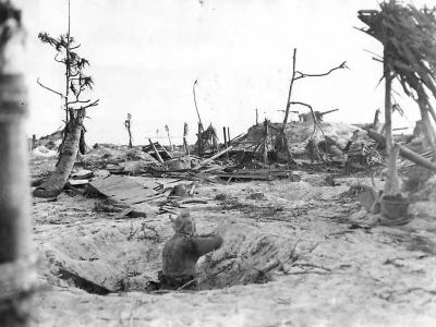 Marine fires on Japanese sniper from Kwajalein shell hole