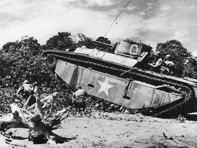 Infantrymen advance under the cover of an LVT