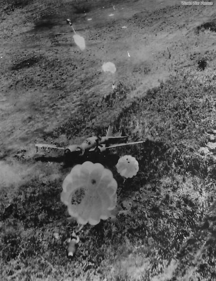 Parachute bombs fall on Japanes plane on airfield at Hollandia