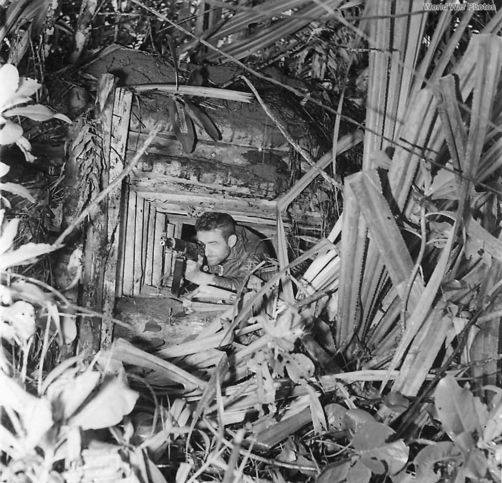 U.S Soldier in captured Japanese machine gun nest on New Guinea 1943