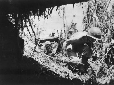 US Signal Corps men advancing under fire on New Guinea
