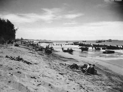 US troops and vehicles along the invasion beach at Korako