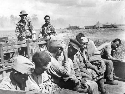 US troops in HBT camouflage uniforms with Japanese POWs in Hollandia