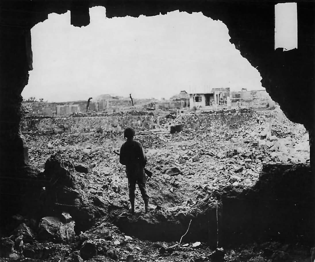 Marine Rifleman Looks over Ruins of Naha Okinawa