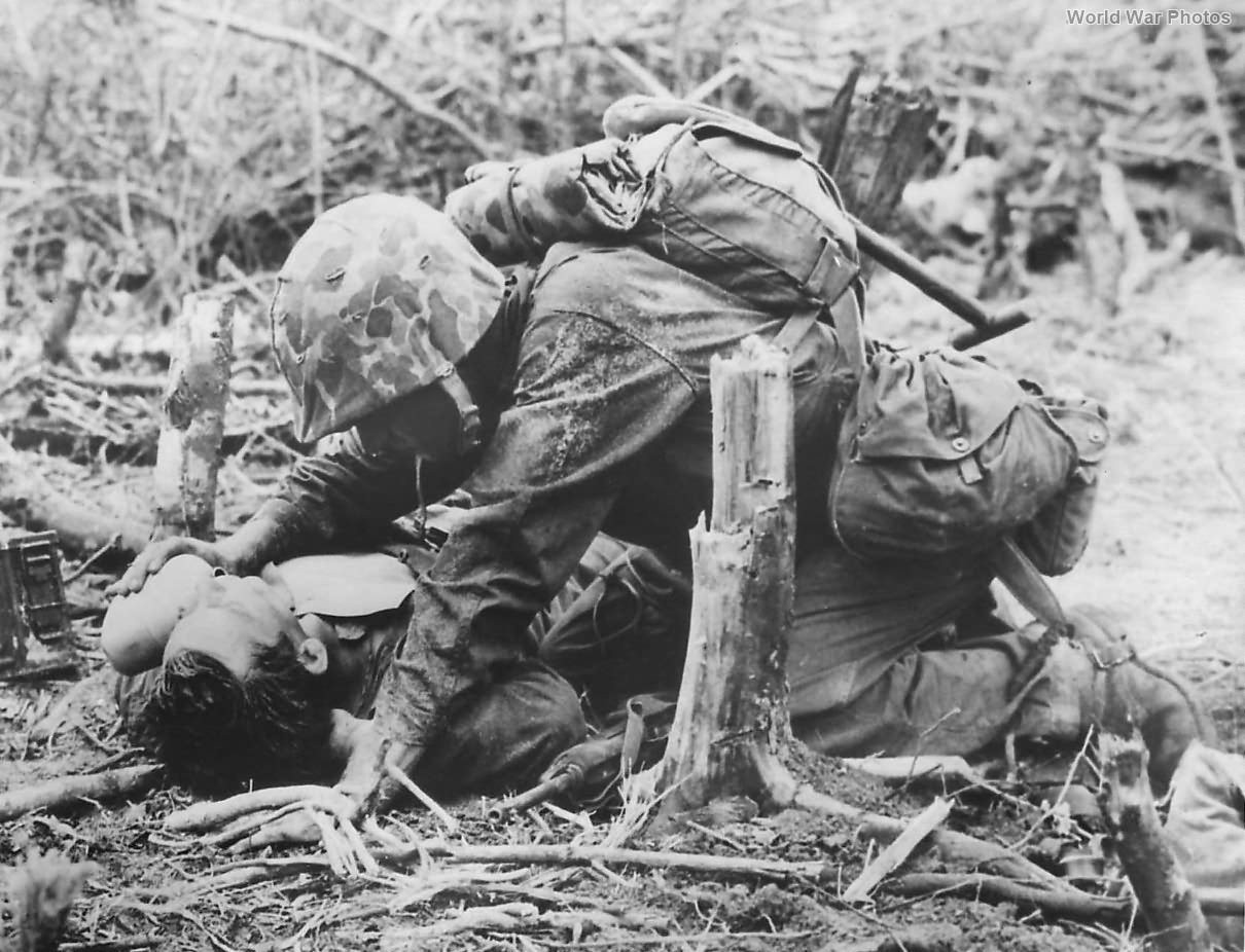 1st Div Marine Gives Water to Wounded Buddy on Peleliu