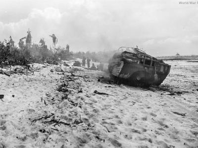 DUKW smoldering on the beach at Peleliu after taking a hit from indirect fire