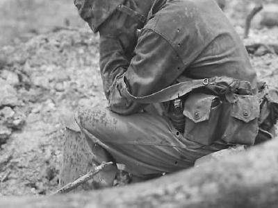 Exhausted Marine weeping atop of Hill 200