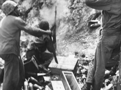 Marine Lobs Grenade toward Japanese Position on Peleliu