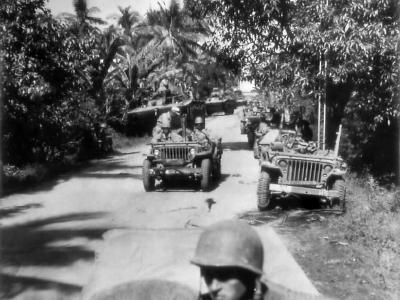 Jeeps and Amtracs loaded with invasion troops move inland on Luzon from Lingayen Gulf
