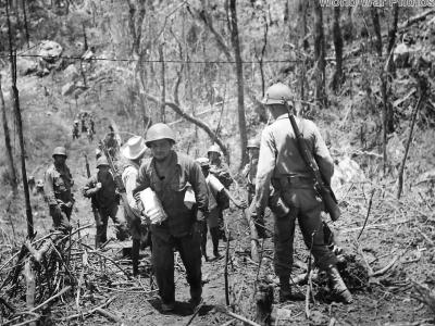 Sgt Peter Kostares delivers mail to his buddies in Company K of the 25th Division along rough jugle trail at Balete Pass Luzon 1945