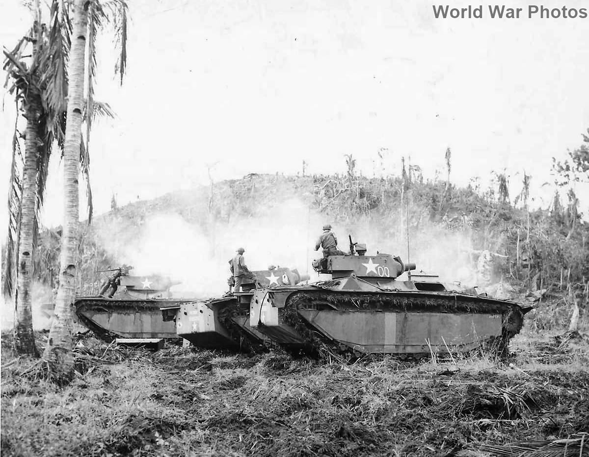 Soldiers atop LVTs in action at Hill 120 on Leyte
