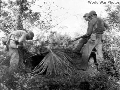 Soldiers check a Japanese pillbox on Luzon as they move inland from beachhead on Lingayen Gulf