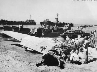 US Forces land by wrecked Japanese plane on Luzon Beach