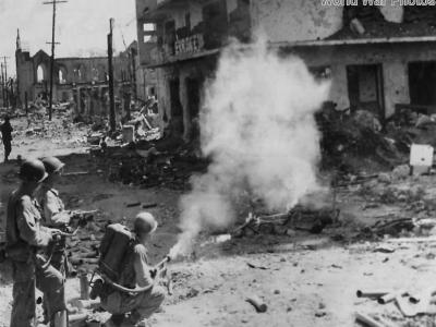 Troops of the 37th Division use flamethrower to blast a Japanese pillbox in the Ermita District of Manila