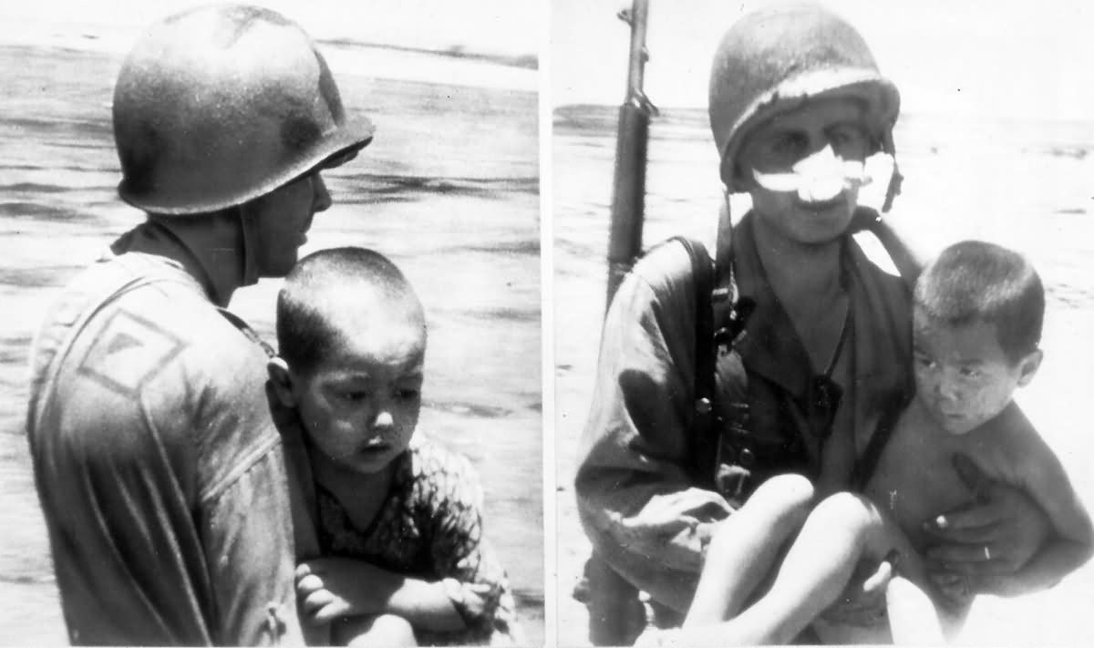 GI’s help carry Japanese kids to safety July 4, 1944 Saipan