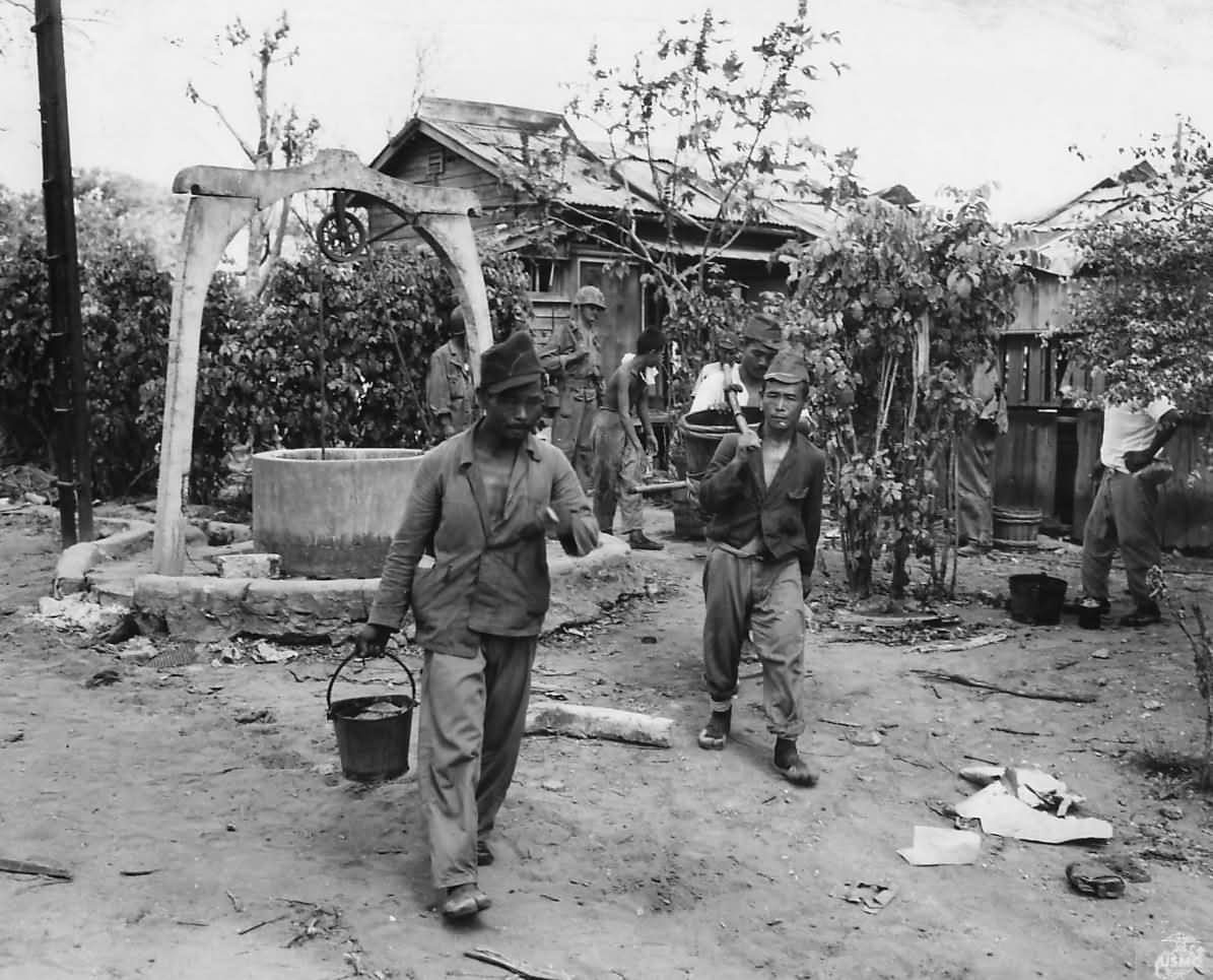 Japanese Work Detail Hauling Water at POW Stockade on Saipan