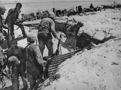 Marines approach Japanese bomb proof shelter on Tarawa