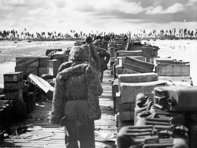USMC reinforcements march down pier