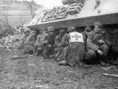 GI’s and German POW take cover by M10 28 February 1945